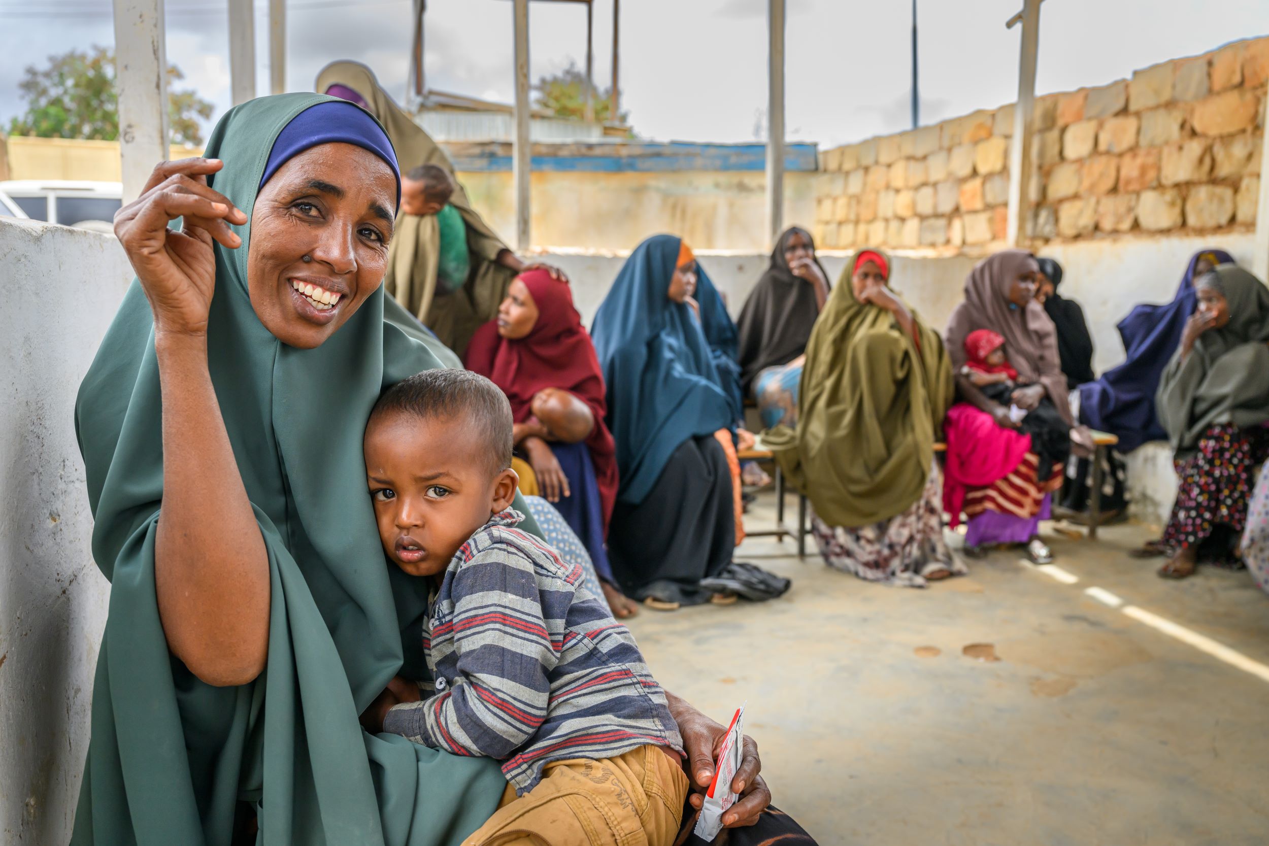 A Somali mother smiles for the camera with her boy at a health centre