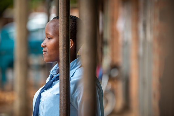 Janet viewed through the bars of her classroom window
