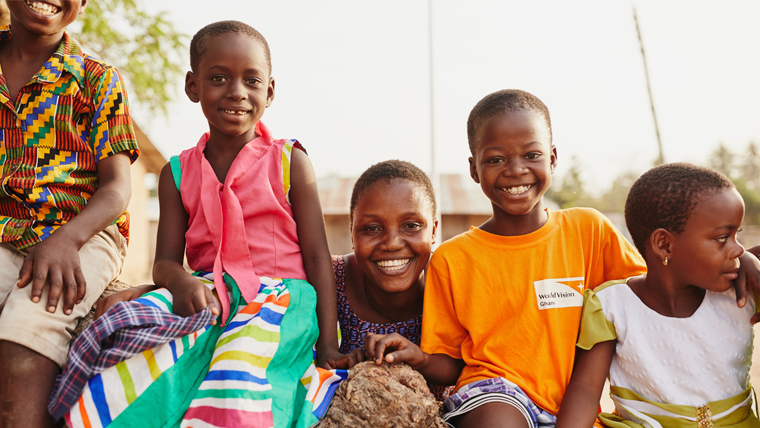 Justine Dzorkp, Community child welfare officer, plays with Akuamoah and his friends.