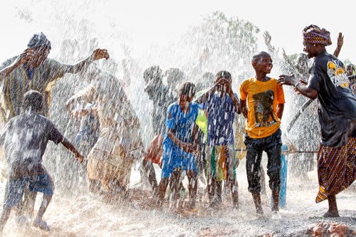 Family dancing in the rain