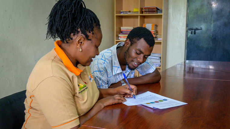 World Vision Kenya staff, Annastasia and Geoffrey, working together