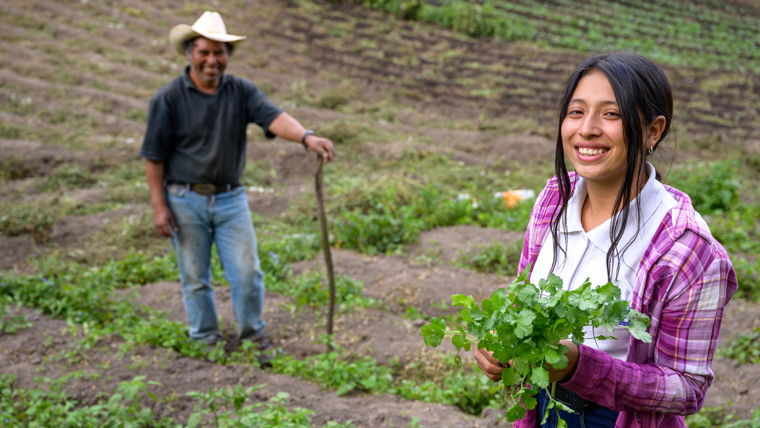 Girl helps in her father's field in Honduras