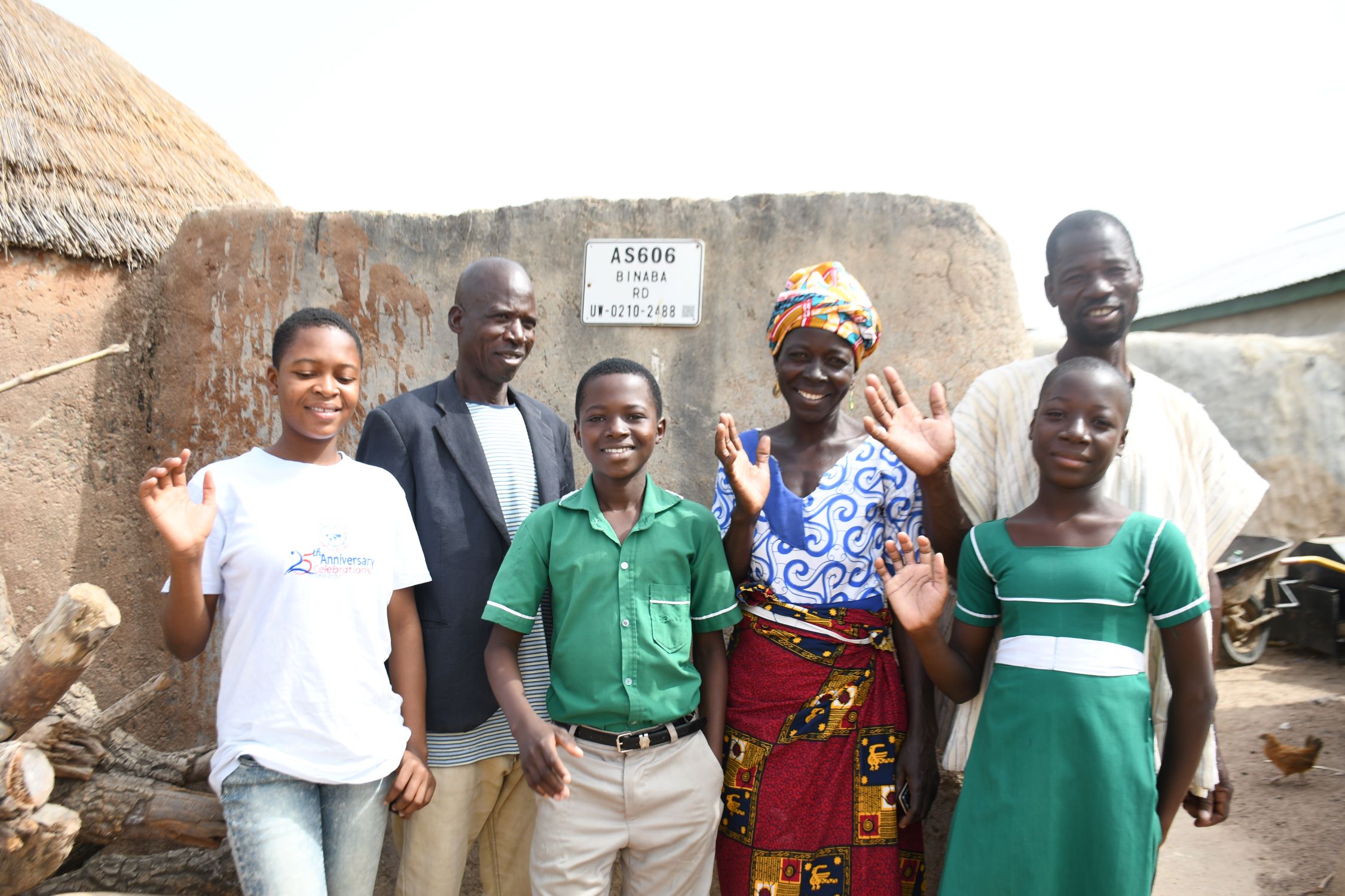 Ghanaian family in front of their home