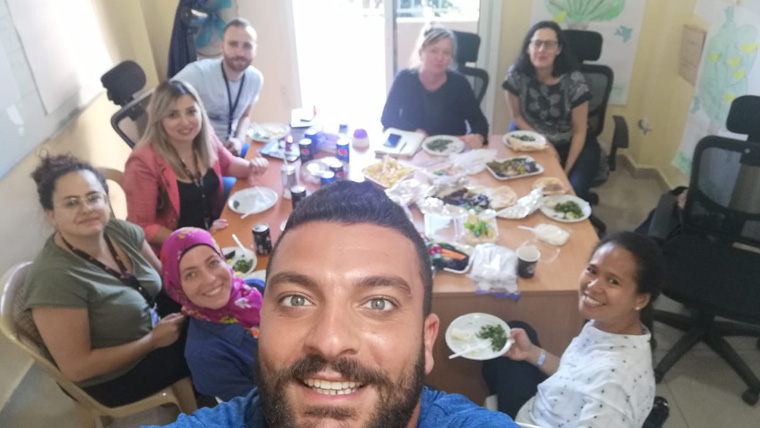 People in Lebanon eat food together around a table